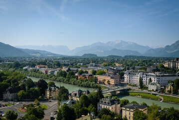 Fototapeta na wymiar View of Salzburg, the river Salzach and the mountains from the old Kapuzinerberg wall on a sunny summer day, Austria