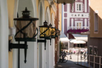 Vintage bronze black street lights in a row on the wall of a building