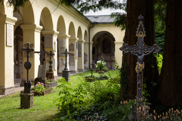 Fototapeta premium Crosses on graves in the cemetery of the late baroque Saint Sebastian's church, Salzburg, Austria