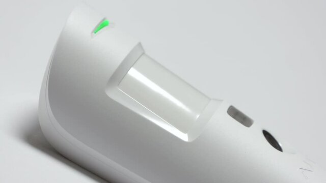 Indoor security system equipment, smart motion detection, wireless motion detector on the wall sends an alarm signal to security company. High quality 4k footage