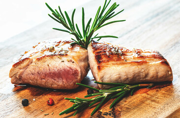 grilled Steak with Rosemary on wooden Table