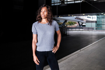 Mature black woman posing on a reflective surface.