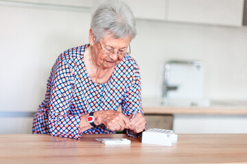 Senior woman putting pills into pill box