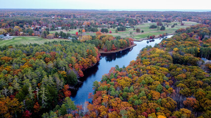 Winding river in small coastal new england maine town - colorful leaves changing - golf course