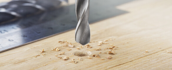 drill bit with steel triangle ruler make sink in hole for screw in wooden oak plank