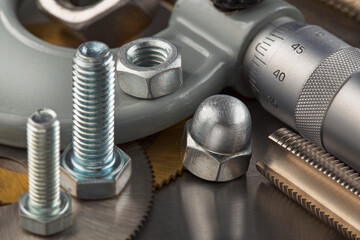 nuts, bolts, screws, washers, bearings on a metal steel background.