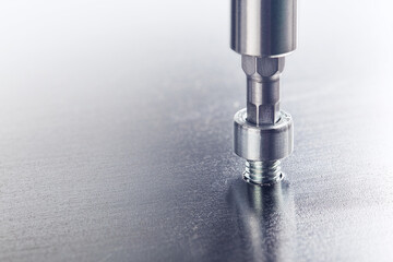 Hex drill bit screw hex bolt in metal steel plate. Spanner, bolt, screw and nuts.