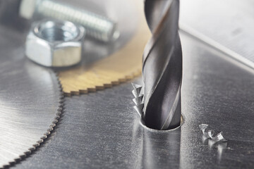 metal drill bit make holes in steel billet on industrial drilling machine. Metal work industry....