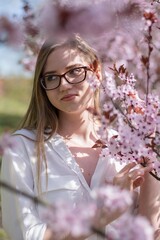 portrait of a girl in a park with pink flowers