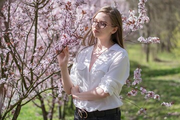 woman in the park with pink flowers © ms16_photo