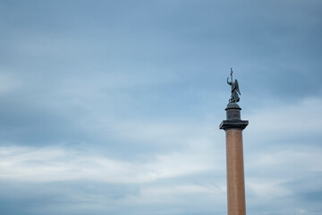 Alexander column on the Palace square against the blue sky in Saint Petersburg.