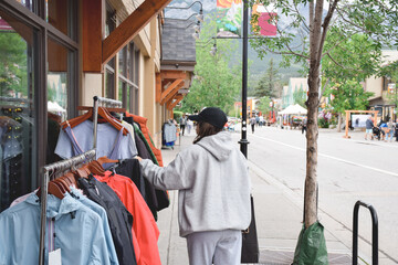 Young girl shopping for clothes on a street