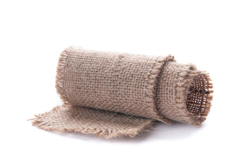Fototapeta na wymiar A piece of burlap tape rolled up. Isolated on white background. 