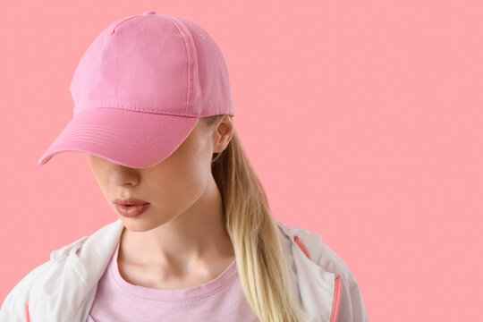 Woman In Baseball Cap On Pink Background, Closeup