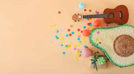 Composition with Mexican pinata, balloons, gifts and guitar on color background