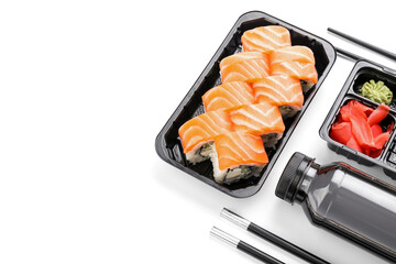 Composition with delicious sushi rolls on white background