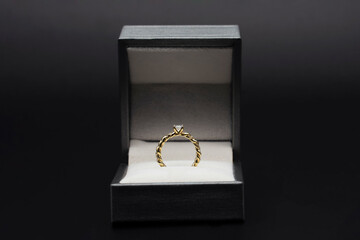 Diamond ring in jewelry gift box on black background