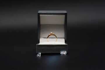Diamond ring in jewelry gift box on black background