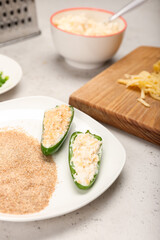 Preparing of jalapeno poppers on light background, closeup