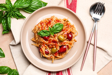 Plate of tasty Pasta Puttanesca on light background