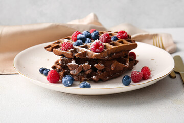 Plate of delicious Chocolate Belgian Waffles with berries on table