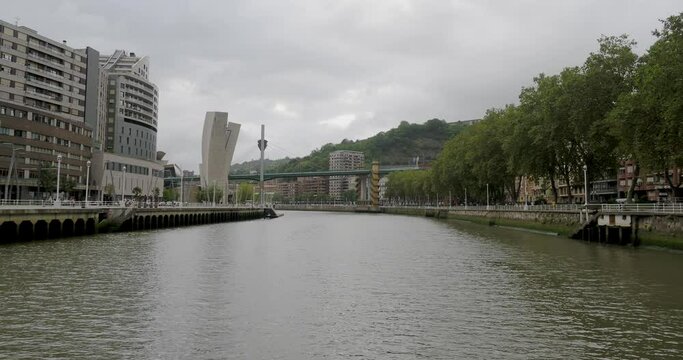 Crossing-boat cruise across the Bilbao river: bridges, urban life, river and buildings of the capital of the Basque Country seen from a boat.