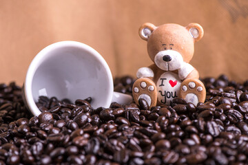 Coffee beans and plush honey. Cup of coffee and beans