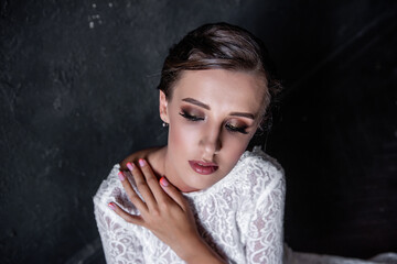 Close-up beauty portrait of young woman. Bright girl, bride with professional evening make-up.