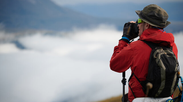 The photographer takes a picture from above the clouds