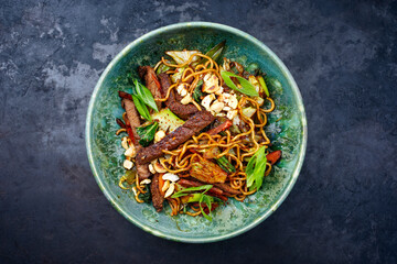 Modern style pad Thai beef with angus roast beef slices, noodles and vegetable served as top view...