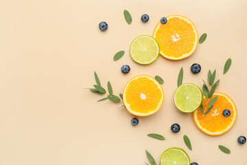 Composition with slices of orange, lime and berries on color background