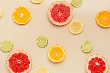 Slices of citrus fruits on color background