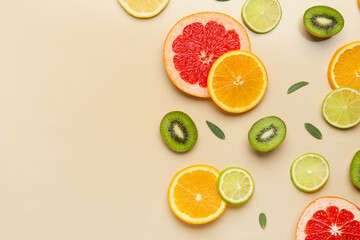 Slices of different fruits on color background