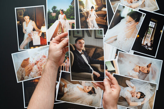 hands lay out wedding photos. the result of the photographer's work at wedding.