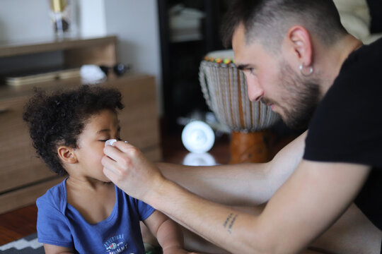 African child playing happily with his dad at home