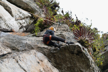 Old man climber on the mountain