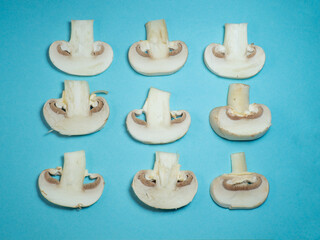Background from cut champignons. Mushrooms on a blue tablecloth