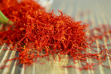 Naklejka premium Close up of oriental saffron dried spice on wooden spoon.