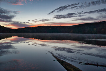 美しい紅葉の白駒池の湖面に反射する日の出