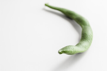 Bean pod close-up. Curved shape, with seeds inside. Space for text. 