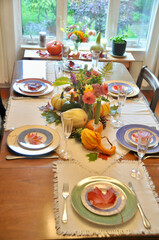 Fall harvest pumpkin and gourds arranged for beautiful seasonal table decor for family Thanksgiving dinner or autumn wedding.