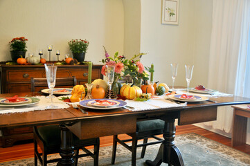 Fall harvest pumpkin and gourds arranged for beautiful seasonal table decor for family Thanksgiving dinner or autumn wedding.