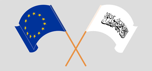 Crossed and waving flags of the European Union and Taliban