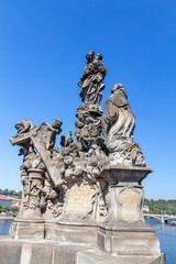 Fototapeta na wymiar Sousosi Madona of St. Bernard statue on the Charles Bridge in Prague, Czechia.
