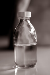 Close up of water in transparent glass bottle