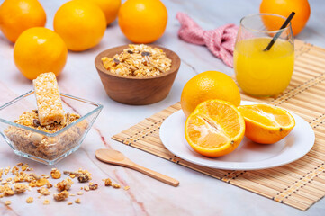 fresh orange juice with whole orange cereals for breakfast or a snack on marble bottom