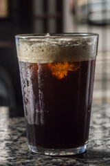 tonic coffee in a traditional american cup, marble table and bar background, coy space