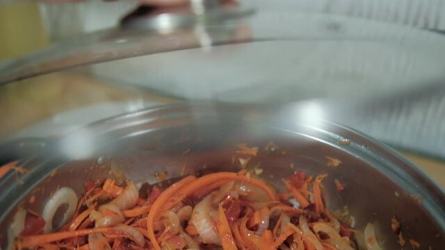 Delicious yam, carrots, tomato, and onion slices in cooking pot
