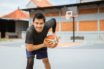 a basketball player holding a basketball in a pose holding the ball while dribbling