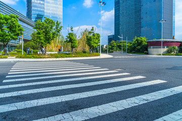 empty road with zebra crossing and skyscrapers in modern city